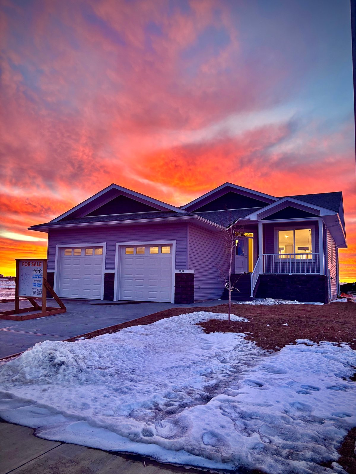 Custom bungalow built by Anchored Custom Homes, photographed at sunset
